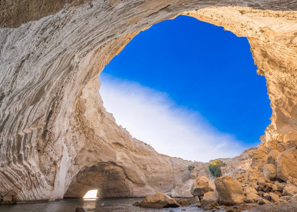 Wide angle shot of Sykia Cave sinkhole and entrance in Melos Island, Greece