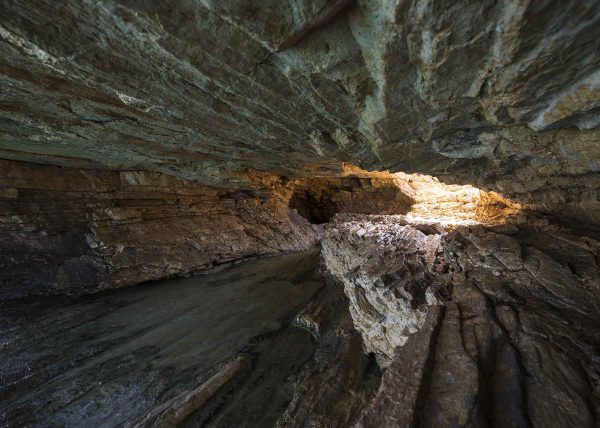 Wide angle shot of Sykia Cave sinkhole and entrance in Melos Island, Greece